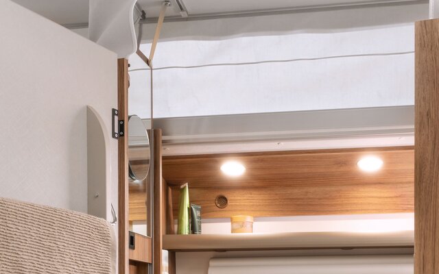 The height-adjustable mirror moves up and down with the pop-top roof. 