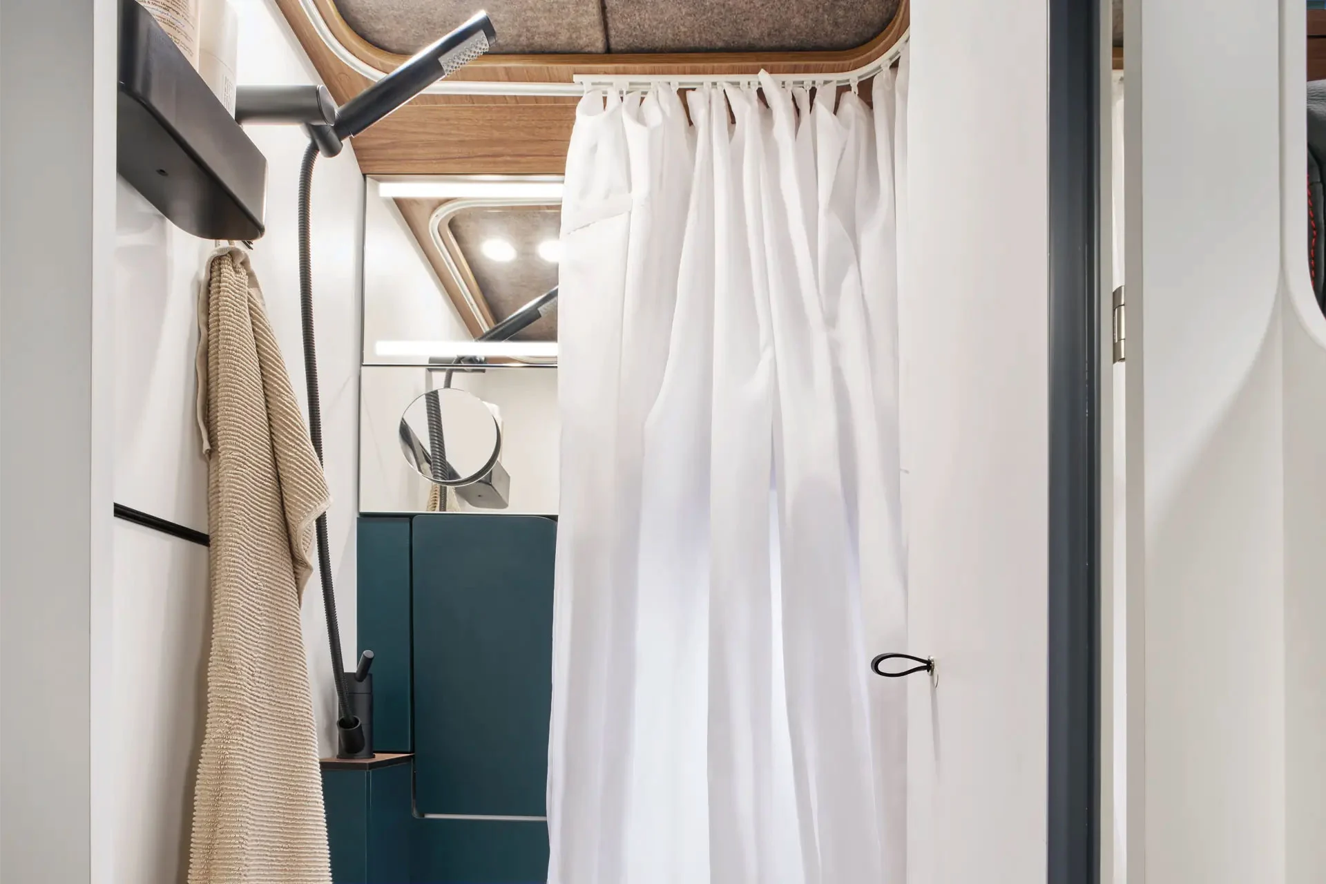 The shower curtain protects the toilet, shelves and walls from splashing water while showering.